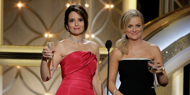 BEVERLY HILLS, CA - JANUARY 12: In this handout photo provided by NBCUniversal, Hosts Tina Fey and Amy Poehler speak onstage during the 71st Annual Golden Globe Award at The Beverly Hilton Hotel on January 12, 2014 in Beverly Hills, California. (Photo by Paul Drinkwater/NBCUniversal via Getty Images)