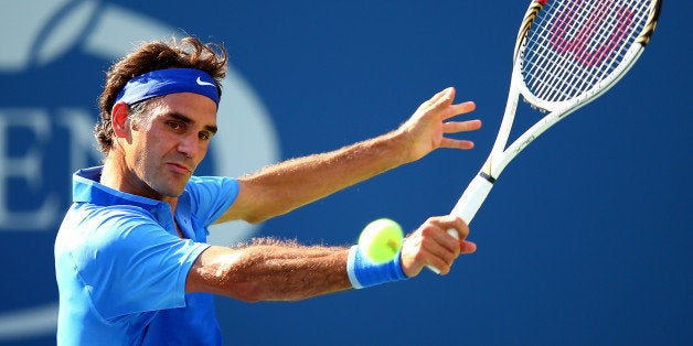 NEW YORK, NY - AUGUST 27: Roger Federer of Switzerland returns a shot to Grega Zemlja of Slovenia during their first round m