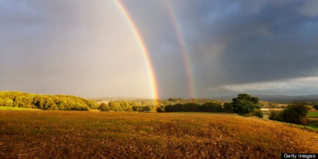 double rainbow rainbow in rural setting, over field in autumn after heavy thunder storm