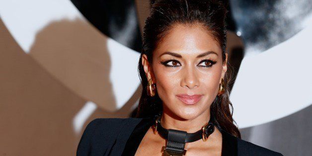 US singer and television personality Nicole Scherzinger poses on the red carpet arriving at the BRIT Awards 2014 in London on February 19, 2014. AFP PHOTO / ANDREW COWIE (Photo credit should read ANDREW COWIE/AFP/Getty Images)