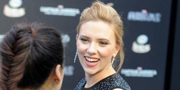 US actress Scarlett Johansson (R) answers a question from a journalist as she arrives to attend a press conference of the film Captain America: The Winter Soldier at a shopping mall in Beijing on March 24, 2014. The movie will be released on April 4. AFP PHOTO / MANDY WANG (Photo credit should read MANDY WANG/AFP/Getty Images)
