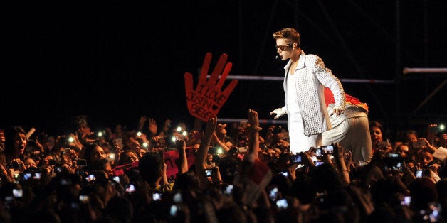 Canadian pop singer Justin Bieber performs during his concert in the Nacional Stadium, in Santiago, on November 12, 2013. AFP PHOTO/Hector RETAMAL (Photo credit should read HECTOR RETAMAL/AFP/Getty Images)