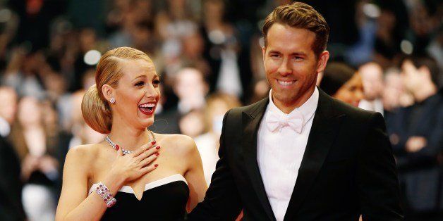 Canadian actor Ryan Reynolds and his wife US actress Blake Lively pose as they arrive for the screening of the film 'Captives' at the 67th edition of the Cannes Film Festival in Cannes, southern France, on May 16, 2014. AFP PHOTO / VALERY HACHE (Photo credit should read VALERY HACHE/AFP/Getty Images)