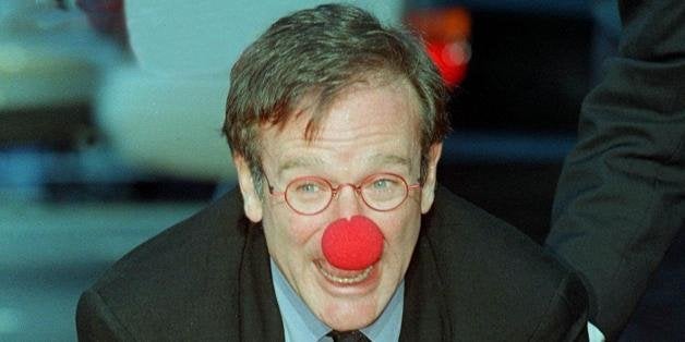 HOLLYWOOD, : Academy Award-winning actor Robin Williams wears a clown nose as he places his hands in cement during his hand and footprint ceremony outside Mann's Chinese Theatre 22 December in Hollywood, California. Williams is currently starring in the critically acclaimed film 'Patch Adams' about a doctor who uses humor to help heal his patients. AFP PHOTO/Vince BUCCI (Photo credit should read Vince Bucci/AFP/Getty Images)