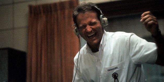 Robin Williams enjoying music through headset in a scene from the film 'Good Morning, Vietnam', 1987. (Photo by Buena Vista/Getty Images)