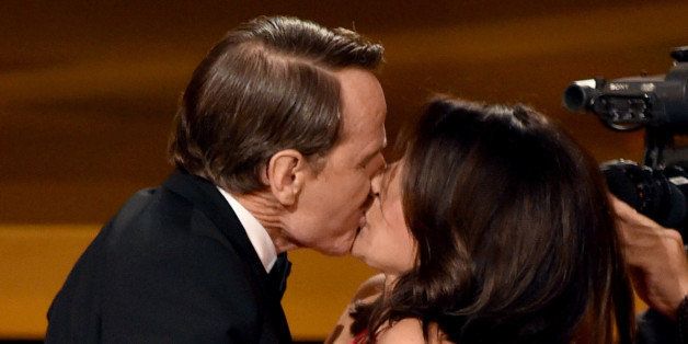 LOS ANGELES, CA - AUGUST 25: Actress Julia Louis-Dreyfus (R) wins Outstanding Lead Actress in a Comedy Series for 'Veep' and kisses actor Bryan Cranston (L) onstage at the 66th Annual Primetime Emmy Awards held at Nokia Theatre L.A. Live on August 25, 2014 in Los Angeles, California. (Photo by Kevin Winter/Getty Images)