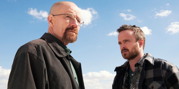 This image released by AMC shows Bryan Cranston as Walter White, left, and Aaron Paul as Jesse Pinkman in a scene from "Breaking Bad." The show was nominated for a Golden Globe for best drama series on Thursday, Dec. 12, 2013. The 71st annual Golden Globes will air on Sunday, Jan. 12. (AP Photo/AMC, Frank Ockenfels )