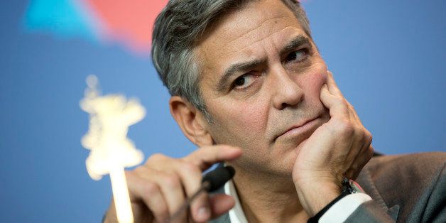 Actor George Clooney arrives at the press conference for the film The Monuments Men during the International Film Festival Berlinale, in Berlin, Saturday, Feb. 8, 2014. (AP Photo/Axel Schmidt)