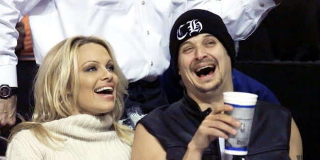 Detroit rock star Kid Rock, right, and his girlfriend, former ``Baywatch'' star Pamela Anderson enjoy the Detroit Pistons game against the Miami Heat Sunday, Dec. 30, 2001, in Auburn Hills, Mich. (AP Photo/Duane Burleson)