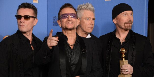 From left, Larry Mullen Jr., Bono, Adam Clayton, and The Edge of U2 pose in the press room with the award for best original song for "Ordinary Love" from the film "Mandela: Long Walk to Freedom" at the 71st annual Golden Globe Awards at the Beverly Hilton Hotel on Sunday, Jan. 12, 2014, in Beverly Hills, Calif. (Photo by Jordan Strauss/Invision/AP)