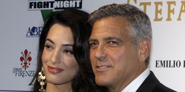 George Clooney and his fiancee Amal Alamuddin pose for photographers as they arrive for the "Celebrity Fight Night" foundation gala dinner, in Florence, Italy, Sunday, Sept. 7, 2014. (AP Photo/Francesco Bellini)