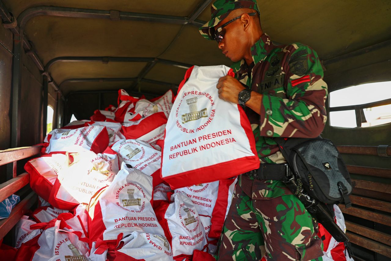 Soldiers unload relief supplies from a military aircraft at Mutiara Sis Al Jufri Airport in Palu.