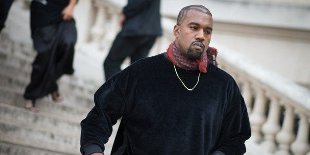 PARIS, FRANCE - SEPTEMBER 24: Kanye West Dries van Noten show in front of the Rochas show in the streets of Paris during the Paris fashion week on September 24, 2014 in Paris, France. (Photo by Timur Emek/Getty Images)