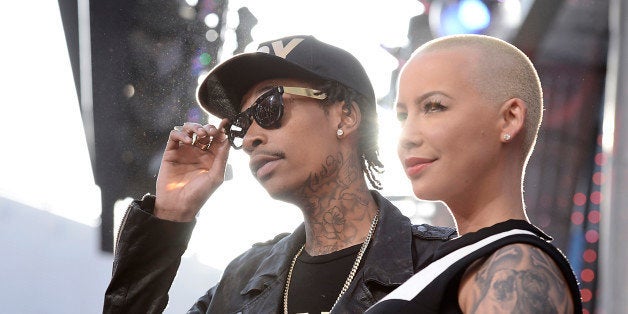 FILE - In this May 21, 2013 file photo, rapper Wiz Khalifa, left, and Amber Rose arrive at the LA Premiere of the "Fast & Furious 6" in Universal City, Calif. Rose filed for divorce from Khalifa on Tuesday, Sept. 23, 2014, in Los Angeles. The model cited irreconcilable differences as the reason for the couple's breakup after a year of marriage. (Photo by Dan Steinberg/Invision/AP)