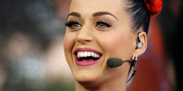 Singer Katy Perry cheers for Mississippi during a telecast of ESPN's College GamDay in The Grove at the University of Mississippi prior to their NCAA college football game against Alabama in Oxford, Miss., Saturday, Oct. 4, 2014. (AP Photo/Rogelio V. Solis)