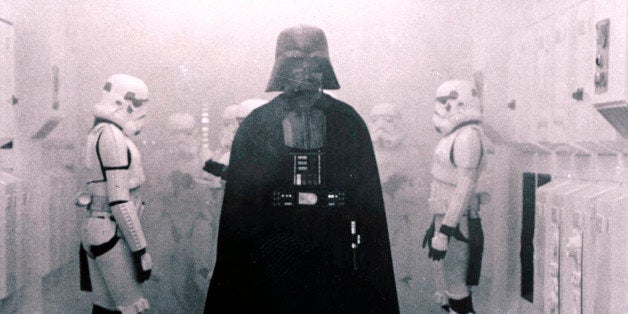 In this 1977 image provided by 20th Century-Fox Film Corporation, Darth Vader, played by David Prowse and voiced by James Earl Jones, and his Imperial stormtroopers take over the Rebel Blockade Runner in a scene from "Star Wars." The intergalactic adventure launched in theaters 35 years ago on May 25, 1977, introducing the world to The Force, Luke Skywalker, Darth Vader, Princess Leia, Han Solo and a pair of loveable droids named R2-D2 and C-3PO. (AP Photo/20th Century-Fox Film Corporation)