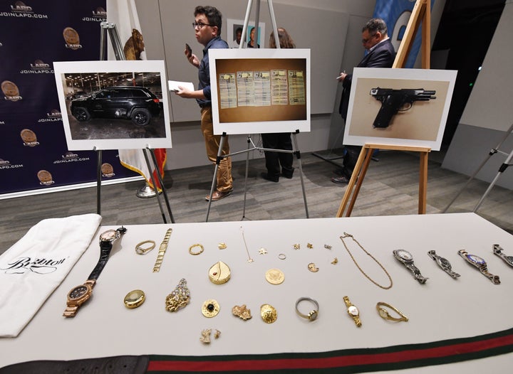 Police displayed seized items believed to have been stolen — including expensive purses, handbags, watches and jewelry — in the hopes that the victims could identify them. 