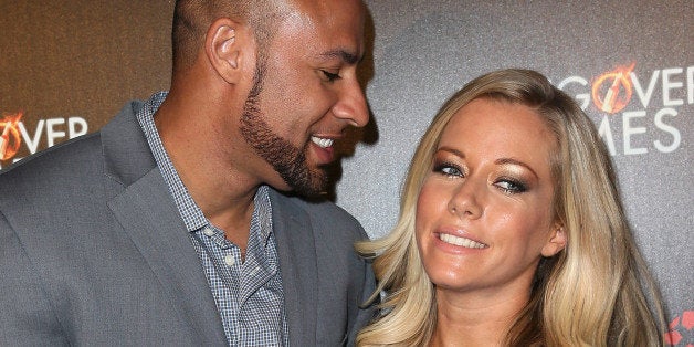 HOLLYWOOD, CA - FEBRUARY 11: Former NFL player Hank Baskett (L) and wife TV personality Kendra Wilkinson attend the premiere