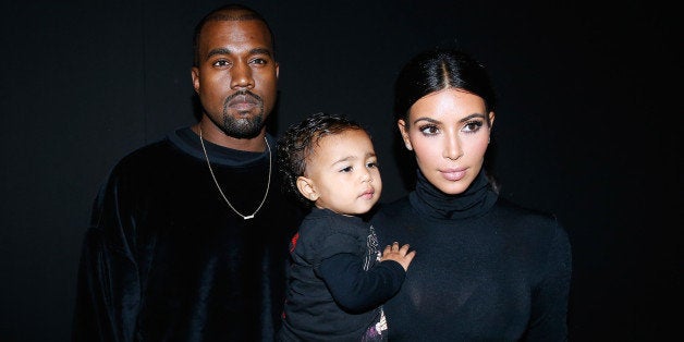PARIS, FRANCE - SEPTEMBER 24: Kanye West, Kim Kardashian and their daughter North West attend the Balenciaga show as part of