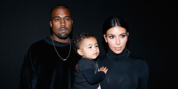 PARIS, FRANCE - SEPTEMBER 24: Kanye West, Kim Kardashian and their daughter North West attend the Balenciaga show as part of the Paris Fashion Week Womenswear Spring/Summer 2015 on September 24, 2014 in Paris, France. (Photo by Bertrand Rindoff Petroff/French Select/Getty Images)