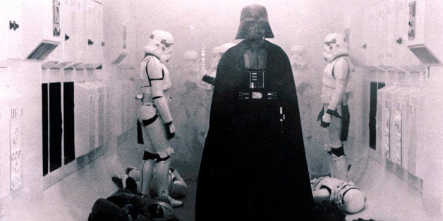 In this 1977 image provided by 20th Century-Fox Film Corporation, Darth Vader, played by David Prowse and voiced by James Earl Jones, and his Imperial stormtroopers take over the Rebel Blockade Runner in a scene from "Star Wars." The intergalactic adventure launched in theaters 35 years ago on May 25, 1977, introducing the world to The Force, Luke Skywalker, Darth Vader, Princess Leia, Han Solo and a pair of loveable droids named R2-D2 and C-3PO. (AP Photo/20th Century-Fox Film Corporation)