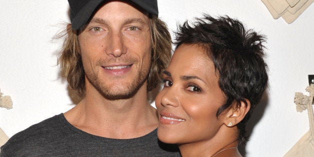 WEST HOLLYWOOD, CA - AUGUST 06: Actress Halle Berry (R) and Gabriel Aubry attend the launch event for Gap's 1969 Jean Shop o