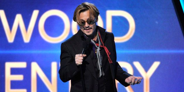 Johnny Depp presents the Hollywood documentary award on stage at the Hollywood Film Awards at the Palladium on Friday, Nov. 14, 2014, in Los Angeles. (Photo by Chris Pizzello/Invision/AP)