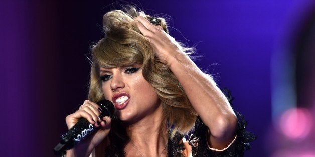 US singer Taylor Swift performs during the 2014 Victoria's Secret Fashion Show at Earl's Court exhibition centre in London on