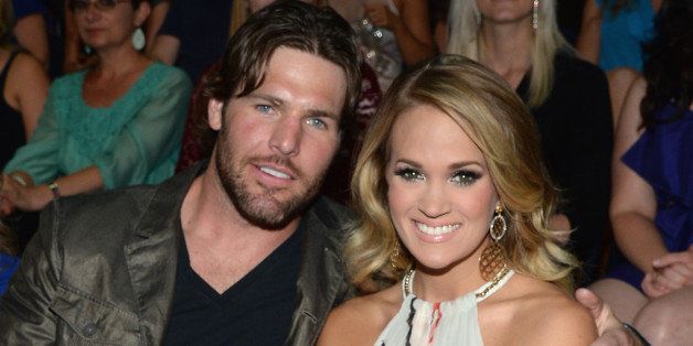 NASHVILLE, TN - JUNE 04: Mike Fisher (L) and Carrie Underwood attend the 2014 CMT Music awards at the Bridgestone Arena on June 4, 2014 in Nashville, Tennessee. (Photo by Larry Busacca/WireImage)