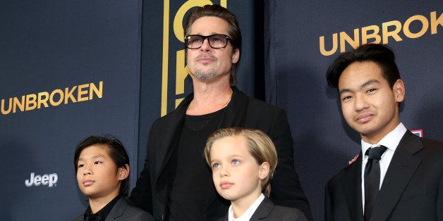 Pax Jolie-Pitt, from left, Brad Pitt, Shiloh Jolie-Pitt and Maddox Jolie-Pitt arrive at the Los Angeles premiere of "Unbroken" at TCL Chinese Theatre on Monday, Dec. 15, 2014. (Photo by Matt Sayles/Invision/AP)