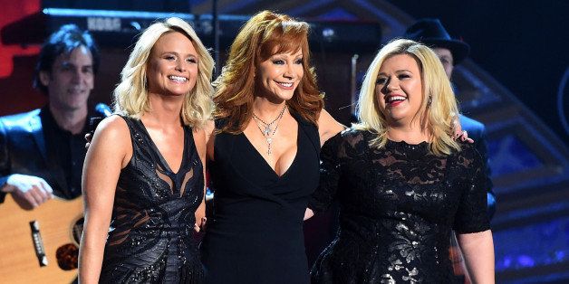 NASHVILLE, TN - DECEMBER 15: (L-R) Recording artist Miranda Lambert, honoree Reba McEntire and recording artist Kelly Clarkson perform onstage during the 2014 American Country Countdown Awards at Music City Center on December 15, 2014 in Nashville, Tennessee. (Photo by Jason Merritt/Getty Images for dcp)