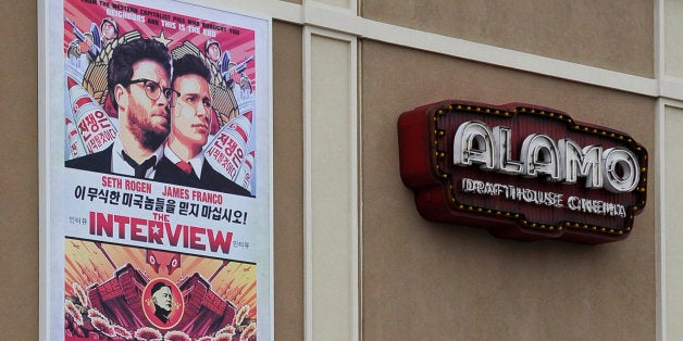 A large poster advertising the movie The Interview hangs on the back wall of the Alamo Drafthouse Cinema Tuesday, Dec. 23, 2014, in Houston. Sony Pictures Entertainment announced Tuesday a limited theatrical release of "The Interview" beginning Thursday, putting back into the theaters the comedy that prompted an international incident with North Korea and outrage over its cancelled release. (AP Photo/Pat Sullivan)