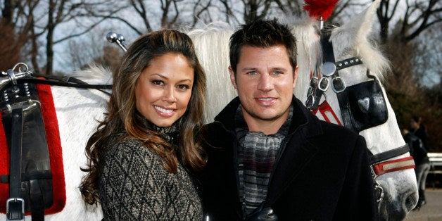Vanessa Minnillo and Nick Lachey pose together with a carriage horse during a promotional event for Nivea in New York's Centr