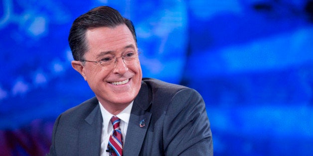 Television personality Stephen Colbert smiles while taping the 'The Colbert Report' with U.S. President Barack Obama, not pic