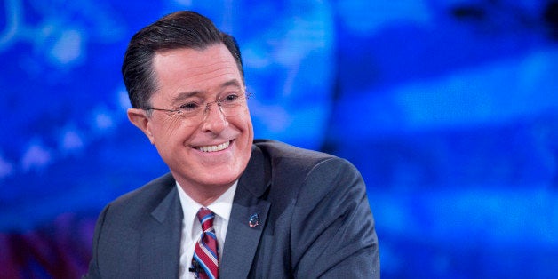 Television personality Stephen Colbert smiles while taping the 'The Colbert Report' with U.S. President Barack Obama, not pictured, in Lisner Auditorium at George Washington University in Washington, D.C., U.S., on Monday, Dec. 8, 2014. This is President Obama's third appearance on 'The Colbert Report' that will broadcast its final show on Dec. 18. Photographer: Andrew Harrer/Bloomberg via Getty Images 