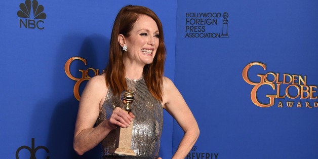 Julianne Moore poses in the press room with the award for best actress in a motion picture - drama for âStill Aliceâ at the 72nd annual Golden Globe Awards at the Beverly Hilton Hotel on Sunday, Jan. 11, 2015, in Beverly Hills, Calif. (Photo by Jordan Strauss/Invision/AP)