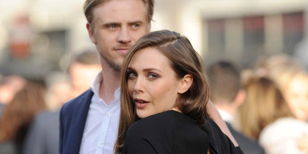 HOLLYWOOD, CA - MAY 08: Actors Boyd Holbrook (L) and Elizabeth Olsen arrive at the Los Angeles premiere of 'Godzilla' at Dolby Theatre on May 8, 2014 in Hollywood, California. (Photo by Axelle/Bauer-Griffin/FilmMagic)