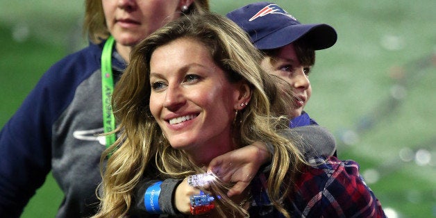 GLENDALE, AZ - FEBRUARY 01: Gisele Bundchen, wife of Tom Brady #12 of the New England Patriots, walks on the field with their son, Benjamin after defeating the Seattle Seahawks during Super Bowl XLIX at University of Phoenix Stadium on February 1, 2015 in Glendale, Arizona. The Patriots defeated the Seahawks 28-24. (Photo by Andy Lyons/Getty Images)