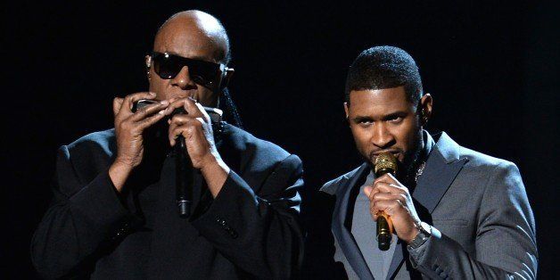 Usher (R) performs on stage with Stevie Wonder at the 57th Annual Grammy Awards in Los Angeles February 8, 2015. AFP PHOTO / ROBYN BECK (Photo credit should read MLADEN ANTONOV,ROBYN BECK/AFP/Getty Images)