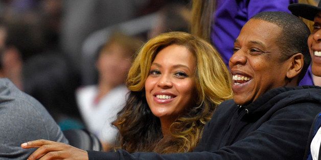 Singer Beyonce, left, and Jay-Z watch during the first half of an NBA basketball game between the Los Angeles Clippers and the Brooklyn Nets, Thursday, Jan. 22, 2015, in Los Angeles. (AP Photo/Mark J. Terrill)
