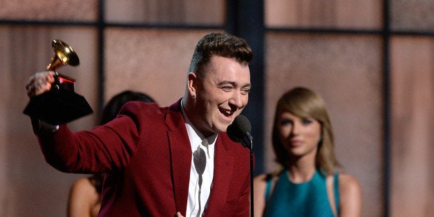 LOS ANGELES, CA - FEBRUARY 08: Singer Sam Smith (L) accepts the Best New Artist award from singer Taylor Swfit onstage during The 57th Annual GRAMMY Awards at the at the STAPLES Center on February 8, 2015 in Los Angeles, California. (Photo by Kevork Djansezian/Getty Images)