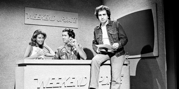 SATURDAY NIGHT LIVE -- Episode 18 -- Air Date 04/24/1976 -- Pictured: (l-r) Raquel Welch as herself, Chevy Chase as himself and Lorne Michaels during the 'Weekend Update' skit on April 24, 1976 (Photo by NBC/NBCU Photo Bank via Getty Images)