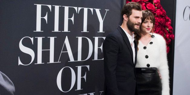 Jamie Dornan and Dakota Johnson attend a special fan screening of "Fifty Shades of Grey" hosted by The Today Show at the Ziegfeld Theatre on Friday, Feb. 6, 2015, in New York. (Photo by Charles Sykes/Invision/AP)