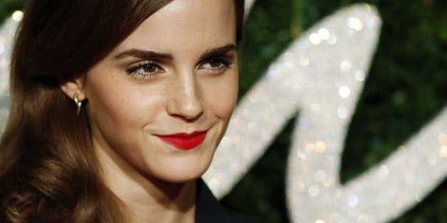 English actress Emma Watson poses for pictures on the red carpet upon arrival to attend the British Fashion Awards 2014 in Lo