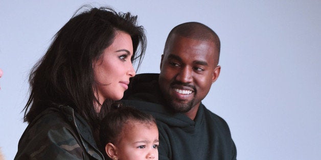 NEW YORK, NY - FEBRUARY 12: Kim Kardashian, North West and Kanye West attend the adidas show during Mercedes-Benz Fashion Week Fall 2015 at Skylight Clarkson SQ. on February 12, 2015 in New York City. (Photo by Gary Gershoff/WireImage)