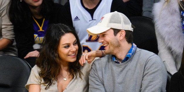 LOS ANGELES, CA - DECEMBER 19: Mila Kunis (L) and Ashton Kutcher attend a basketball game between the Oklahoma City Thunder and the Los Angeles Lakers at Staples Center on December 19, 2014 in Los Angeles, California. (Photo by Noel Vasquez/GC Images)