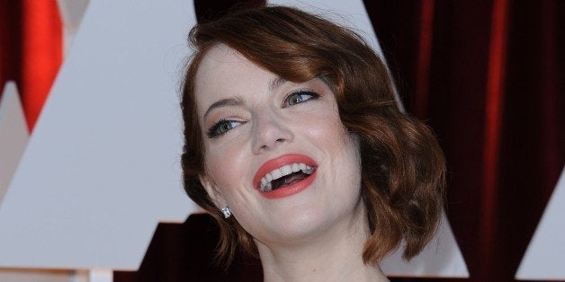 Nominee for Best Supporting Actress Emma Stone arrives on the red carpet for the 87th Oscars on February 22, 2015 in Hollywoo