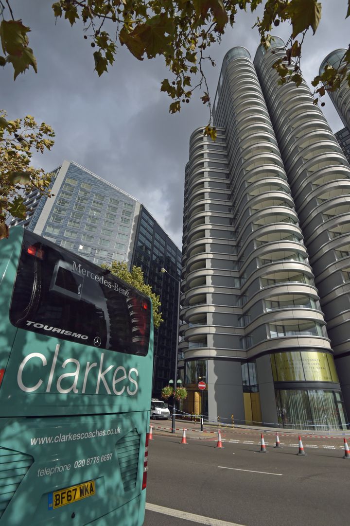 A Clarks of London coach stands idle beside The Corniche development after Tuesday's incident, which saw a full pane of glass fall from the very top floor.