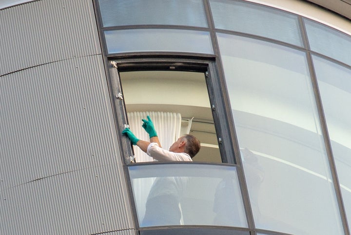 Police inside the apartment where the window fell from 