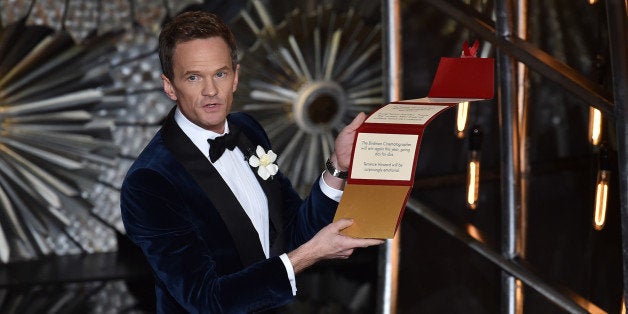 HOLLYWOOD, CA - FEBRUARY 22: Host Neil Patrick Harris opens his locked envelope onstage during the 87th Annual Academy Awards at Dolby Theatre on February 22, 2015 in Hollywood, California. (Photo by Kevin Winter/Getty Images)